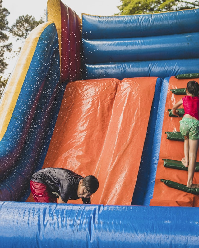 Children playing on an outdoor bouncy castle