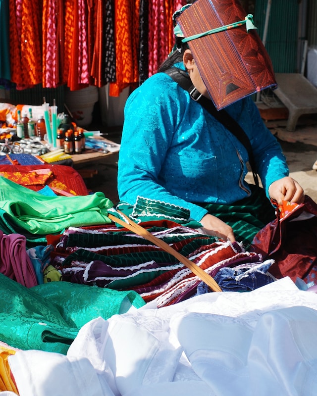 Colourful textiles and clothing displayed at a market fashion stall