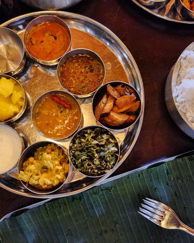 Indian thali platter with rice, curries, and side dishes