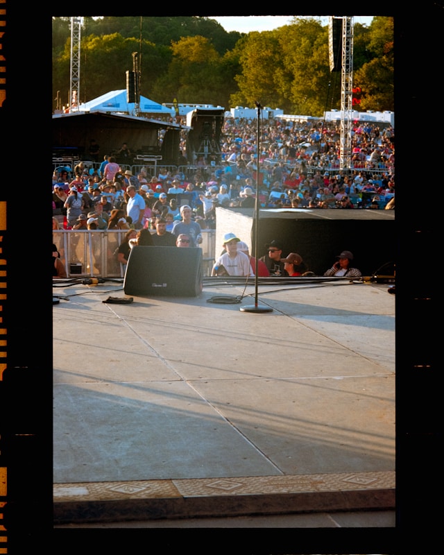 Crowd gathered at an outdoor concert stage for a community performance